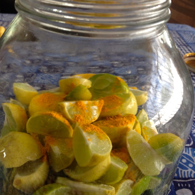 Limes ready to be pickled, anointed with ground turmeric.  Fresh turmeric can be added at this stage too.